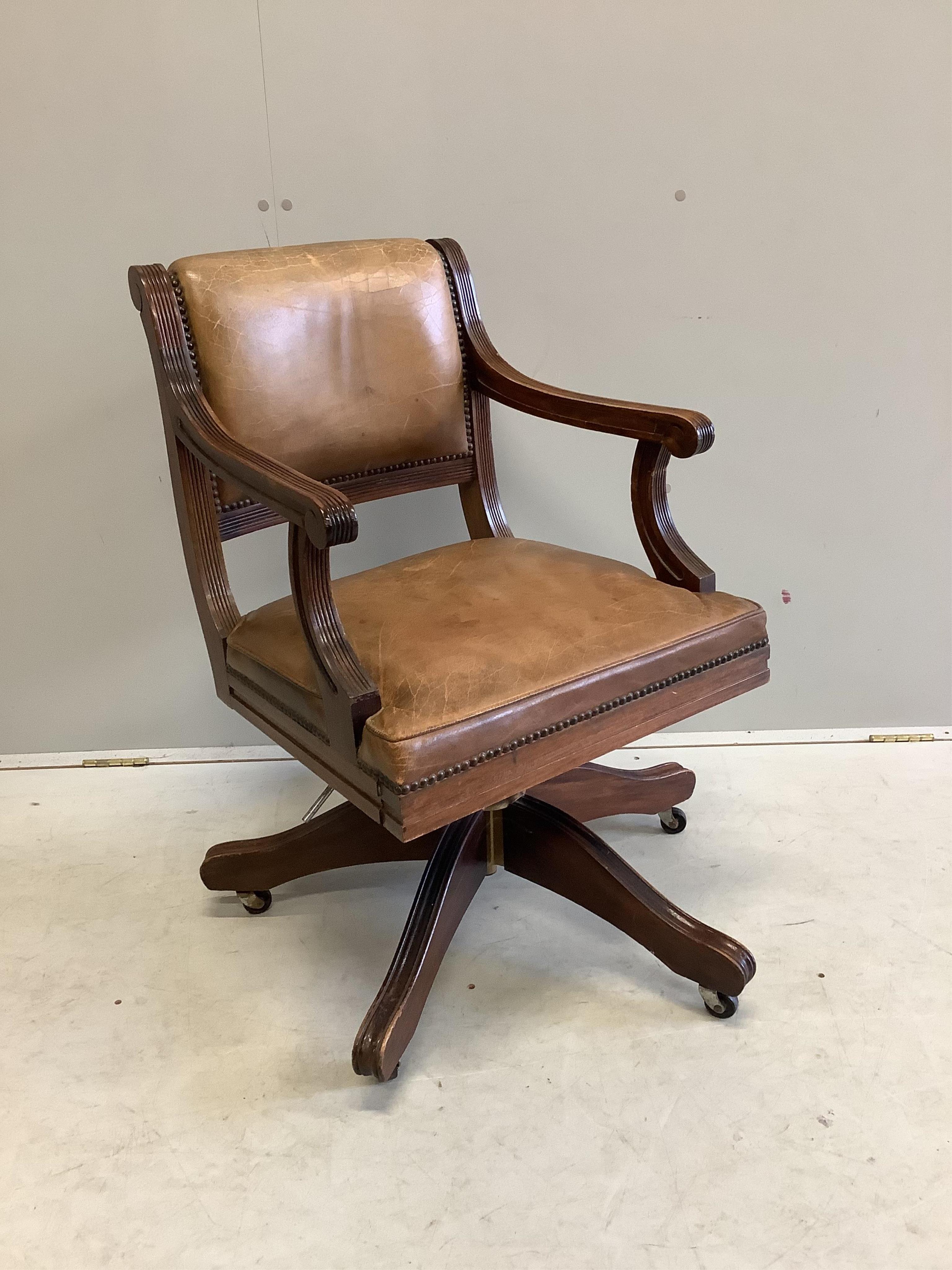 A reproduction mahogany and tan leather swivel desk chair, width 56cm, depth 52cm, height 84cm. Condition - fair